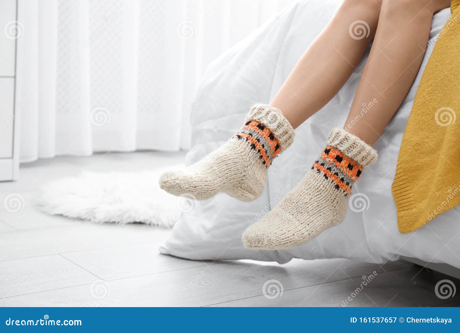 Woman Wearing Knitted Socks On Bed Indoors Warm Clothes Stock Image