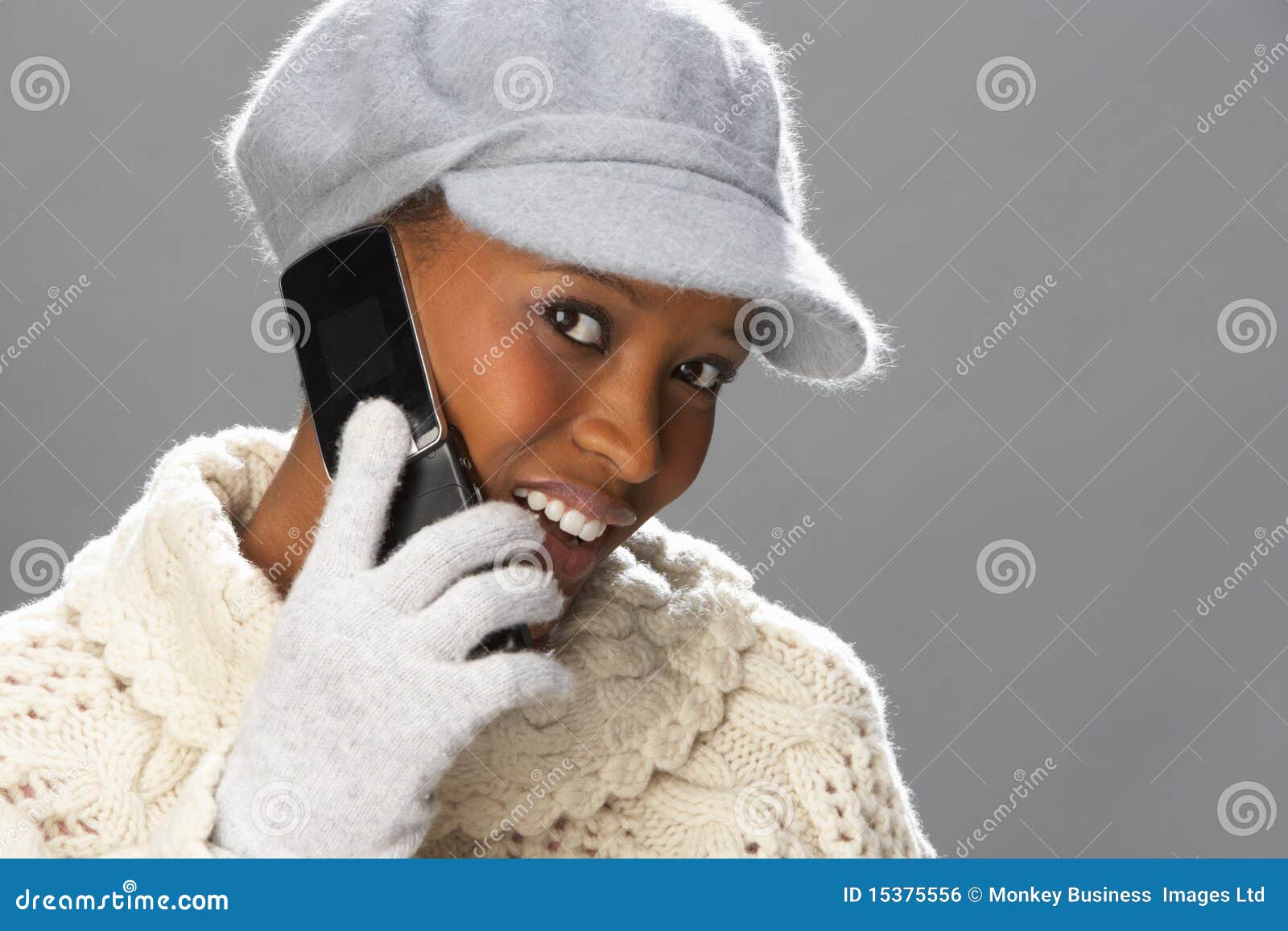 woman wearing knitwear in studio using mobile