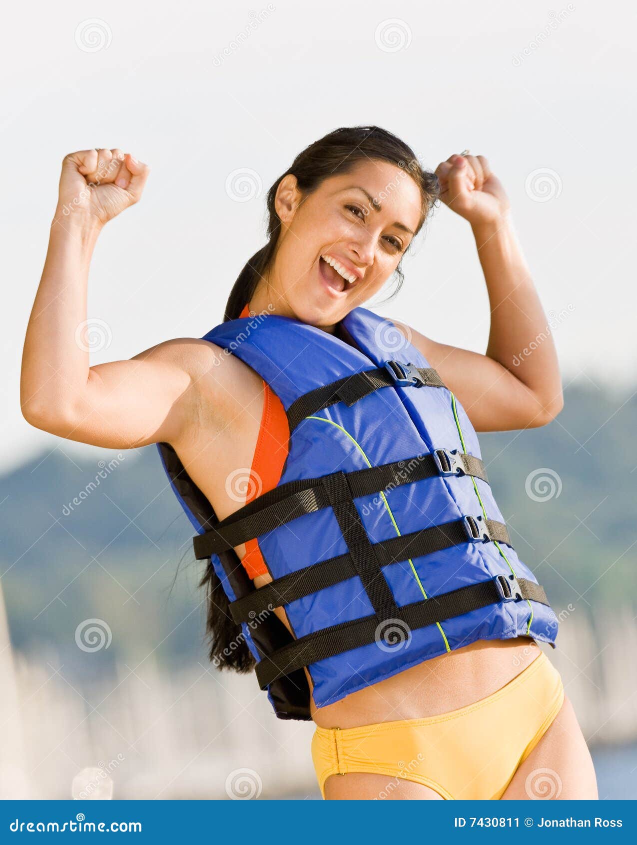woman wearing life jacket at beach