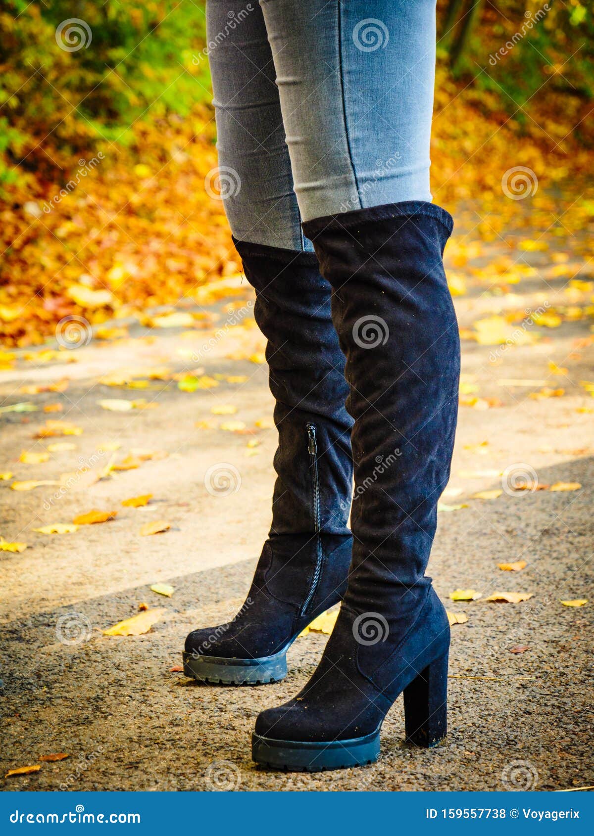 black knee high boots and jeans