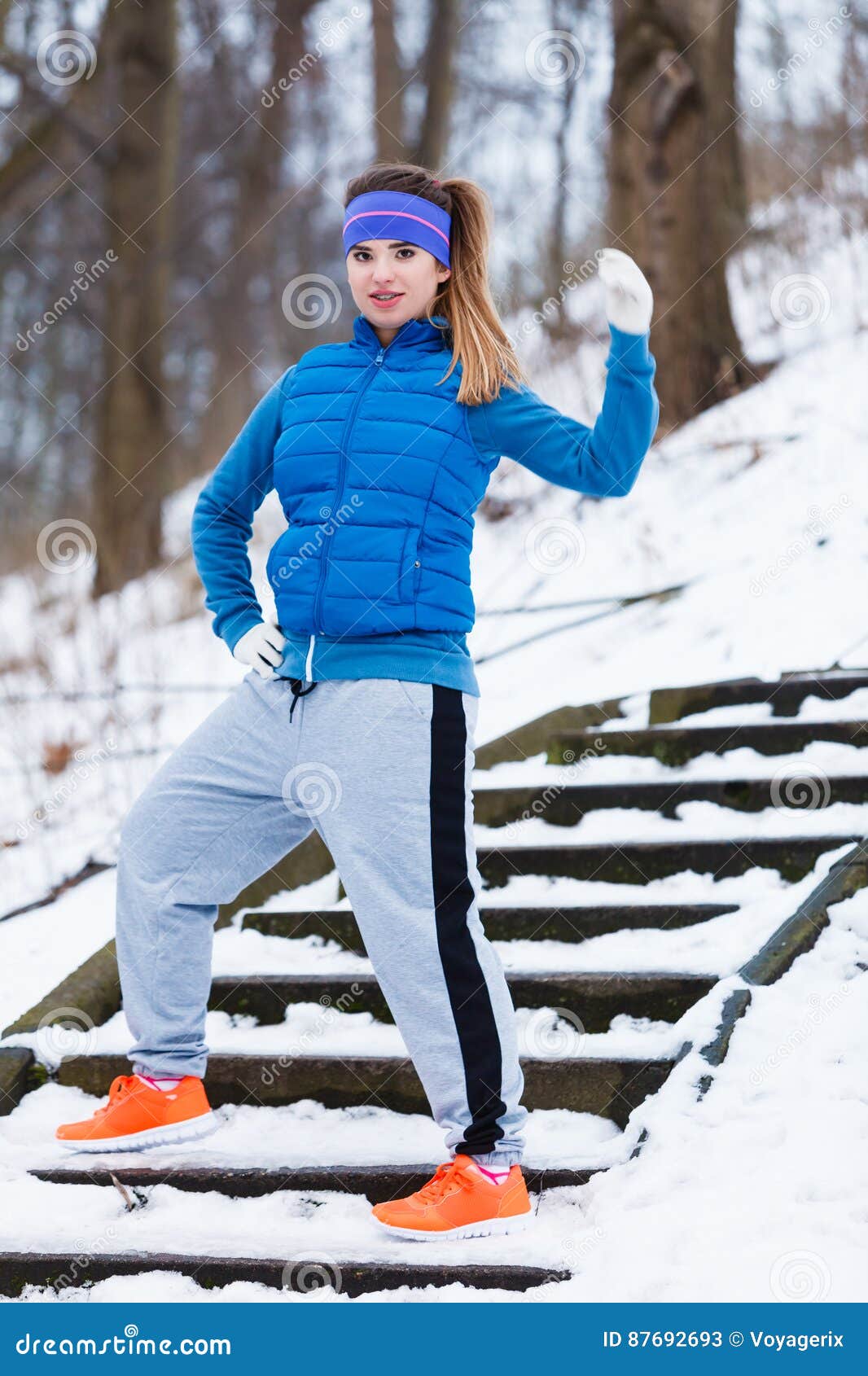 Woman Wearing Sportswear Exercising Outside during Winter Stock