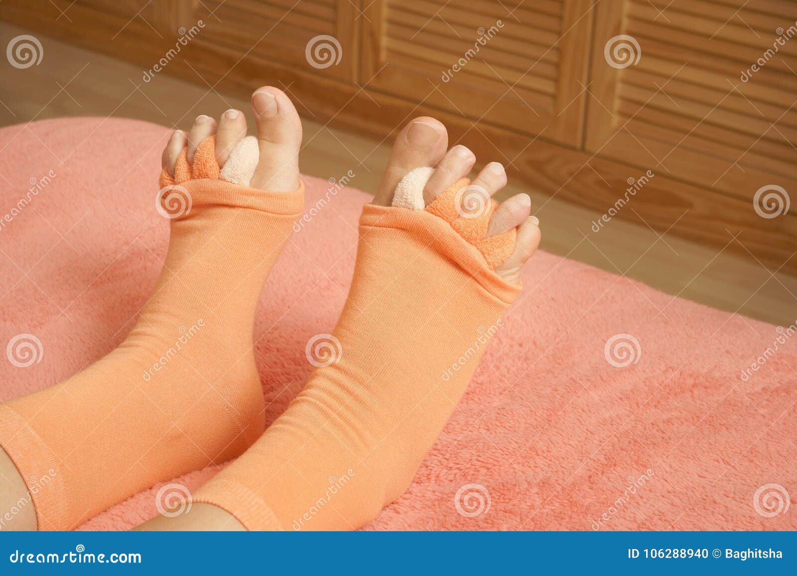 Woman Wearing Yoga Toe Separator Socks in Bed Stock Photo - Image