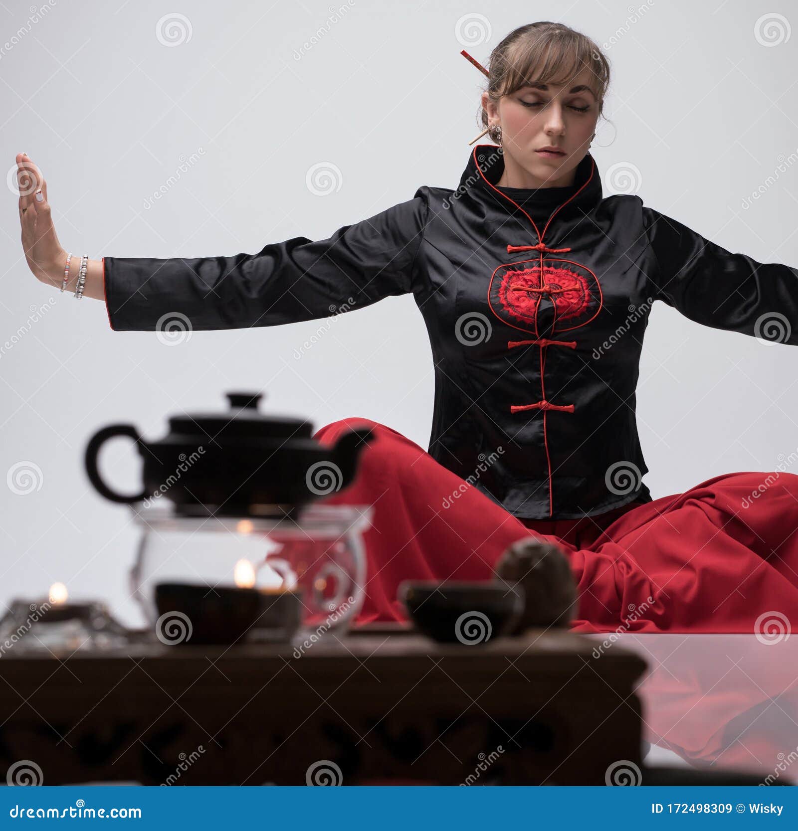 Woman Practicing Wushu Sitting On The Floor Sto