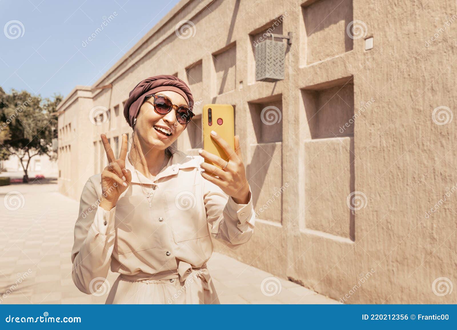 Woman Wearing a Turban Hat Takes a Selfie Against the Backdrop of a Desert  Fortress City on the Arabian Peninsula Stock Photo - Image of arabian,  islam: 220212356