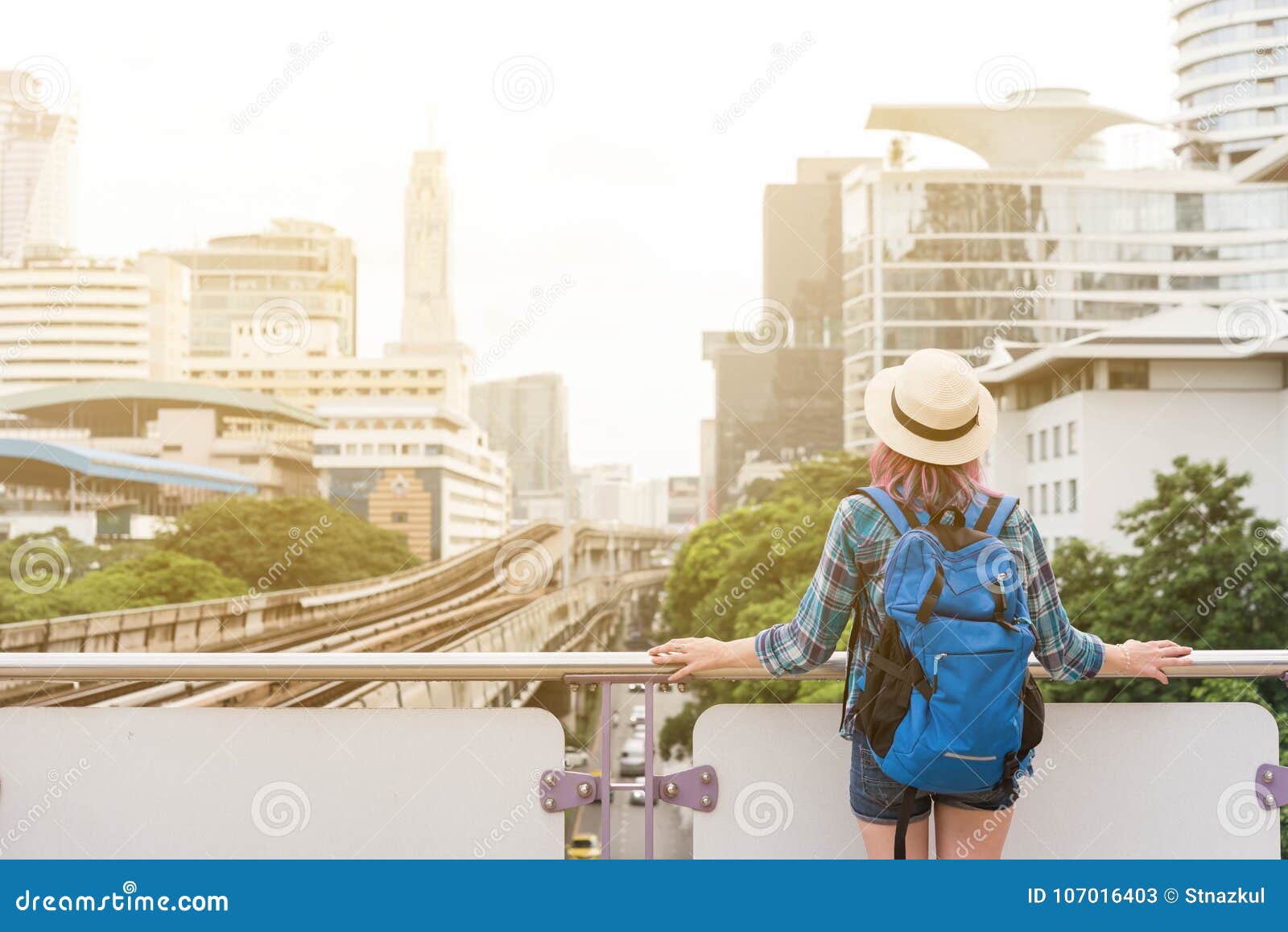 woman westerner admiring the view of city in morning, travelling
