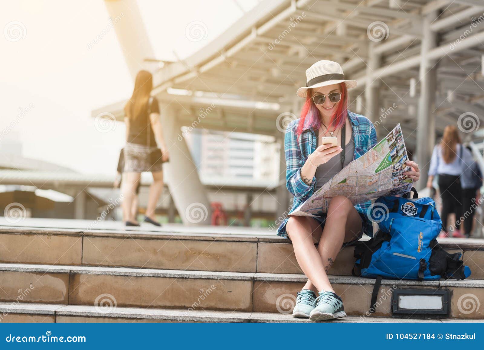 woman westerner looking at map and smartphone during city tour i
