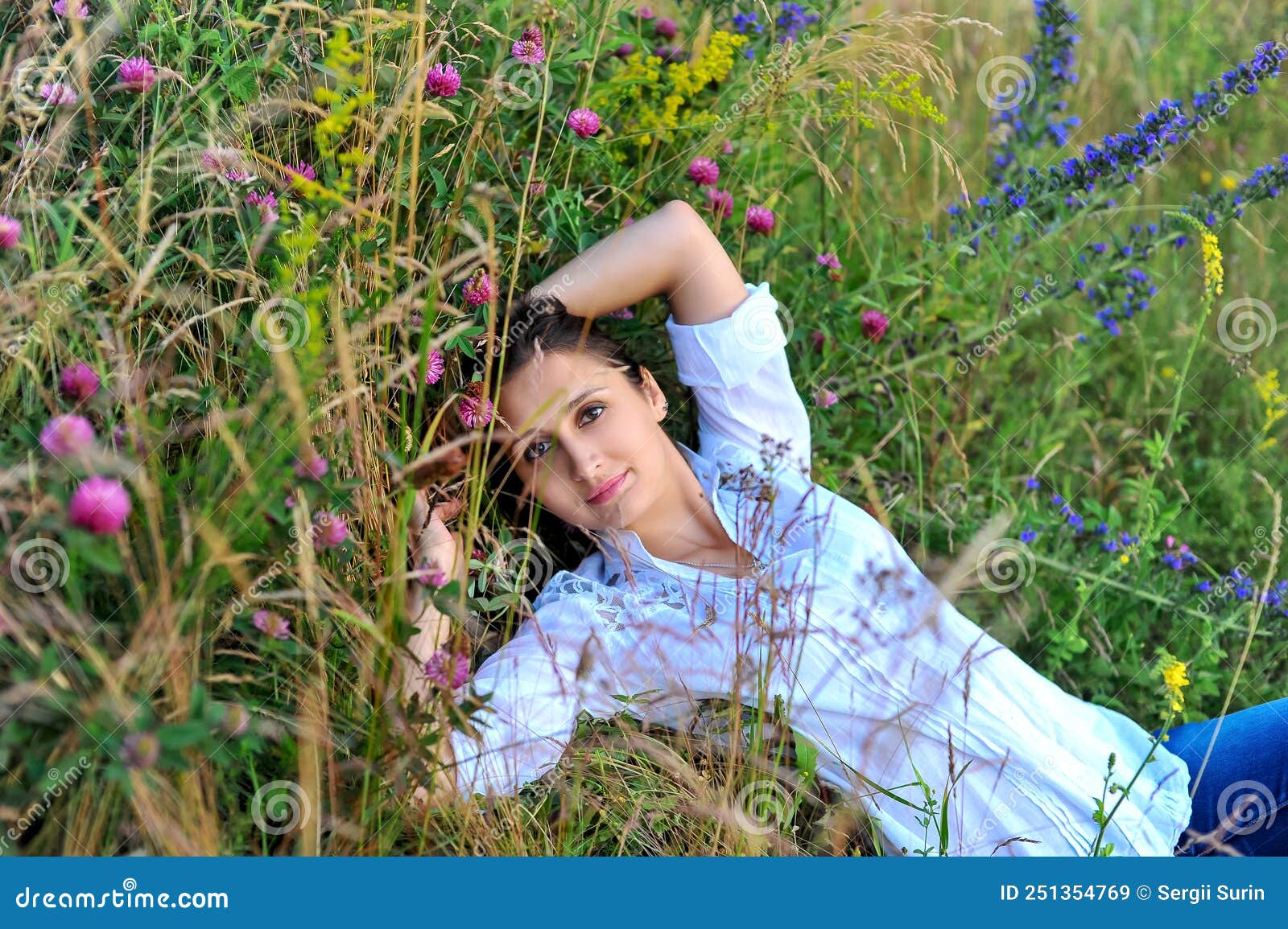 Woman in a White Blouse and Jeans Lies in the Grass Stock Image - Image ...