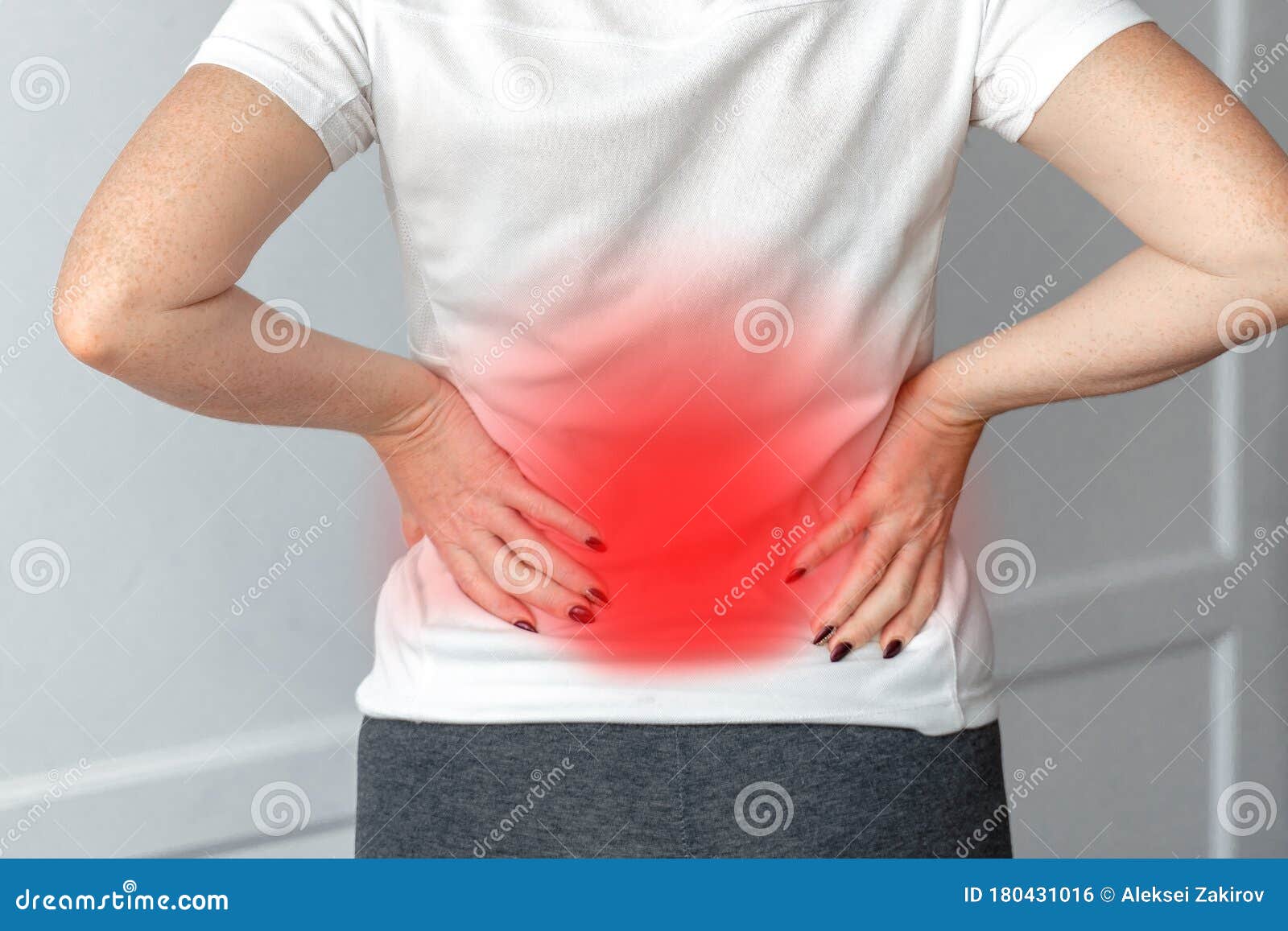 a woman in white dress feeling pain on his back. office syndrome. back pain from work. herniated nucleus pulposus. spine