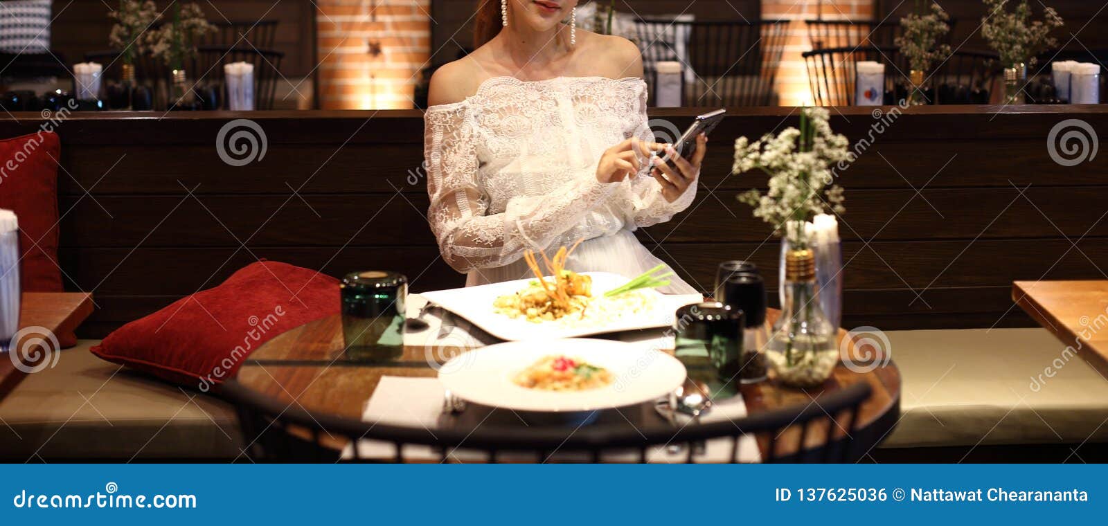 woman white lace dress have dinner in restaurant