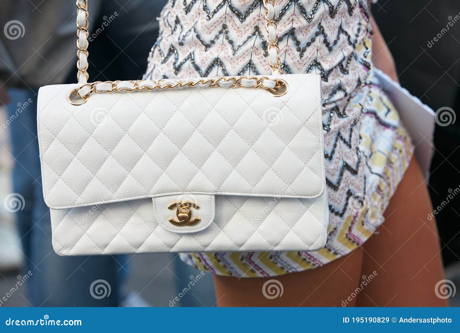 Woman with White Leather Chanel Bag before Salvatore Ferragamo