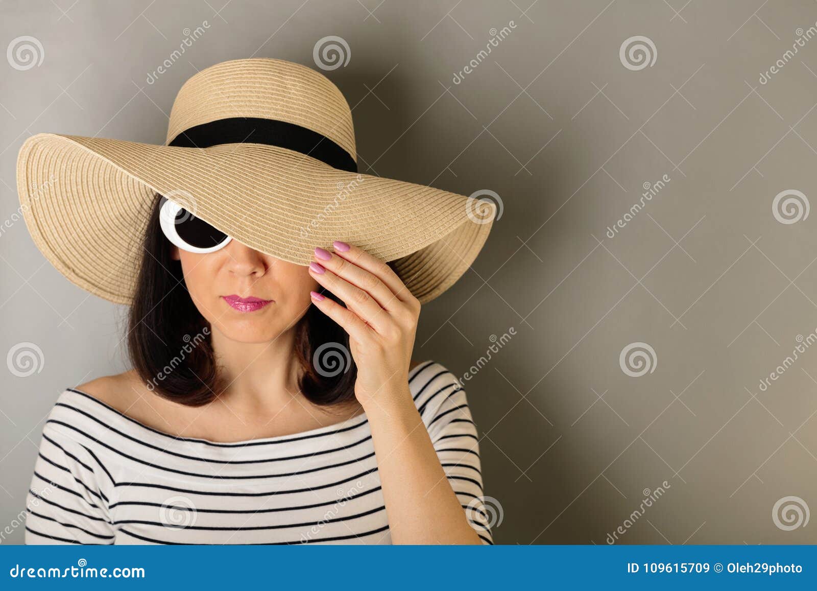 Woman in a White Striped Top, Hat and White Sunglasses. Stock Image
