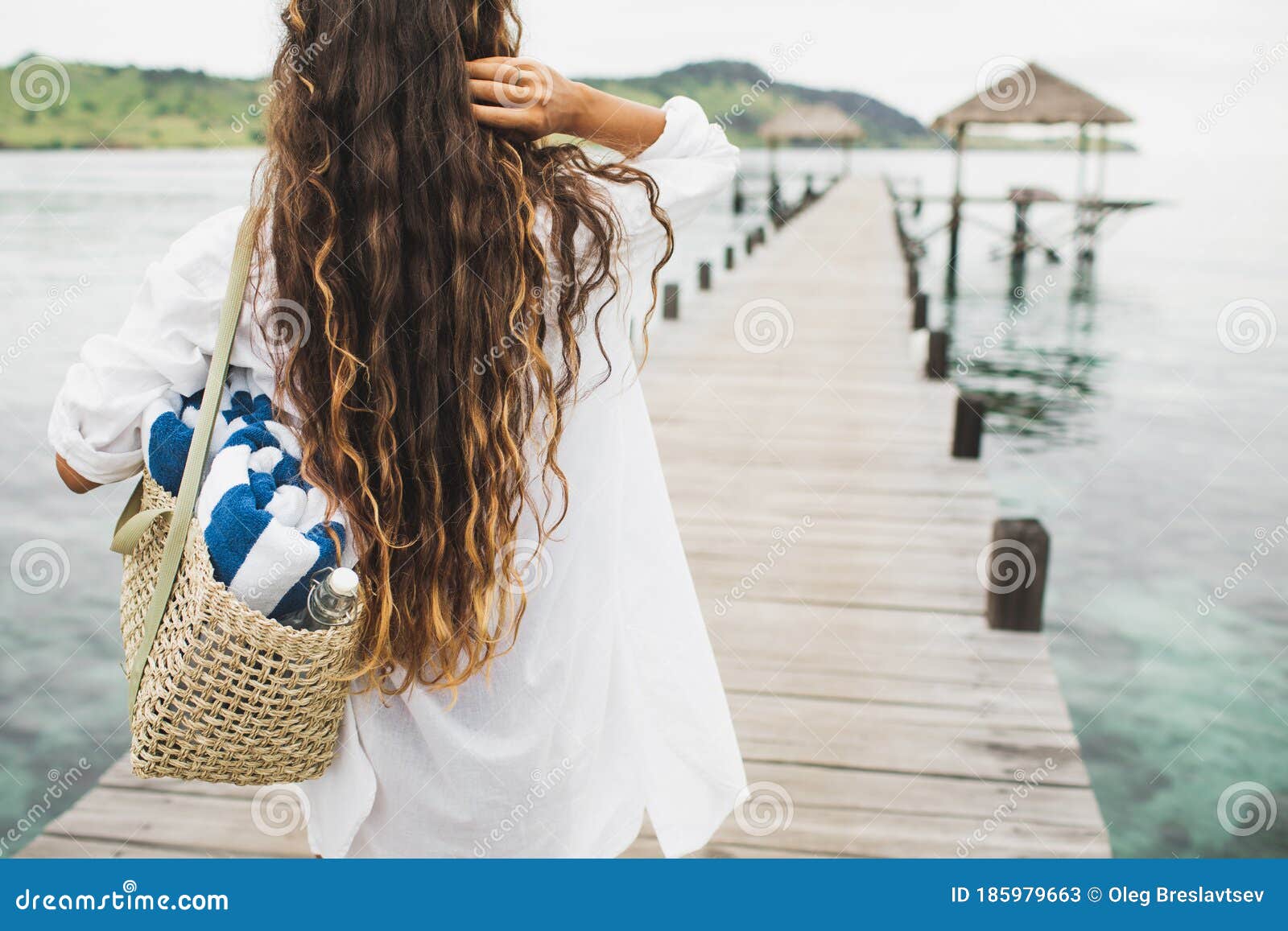 Woman with Wicker Bag, Two Beach Towels and Glass Water Bottle Going To ...