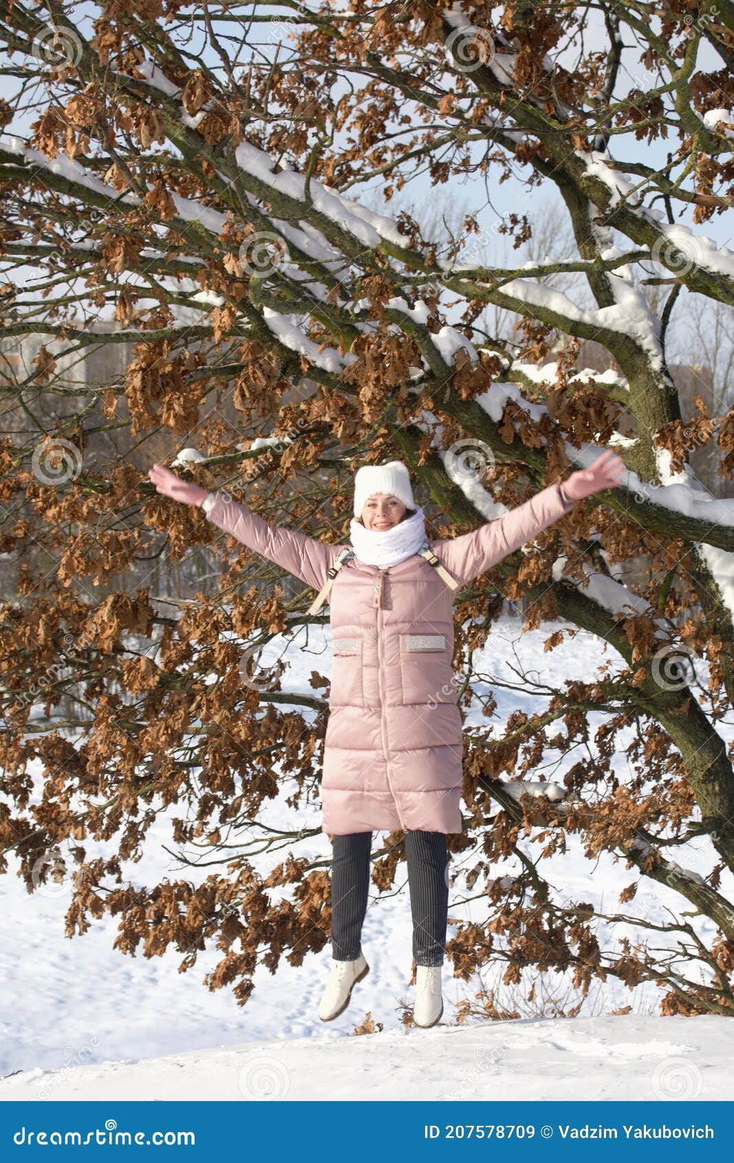 Woman in Winter Clothes on a Walk in the Park. There is a Lot of