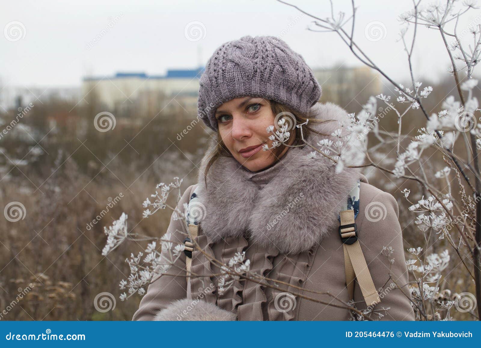 Woman in winter clothes on a walk in the park. There is a lot of