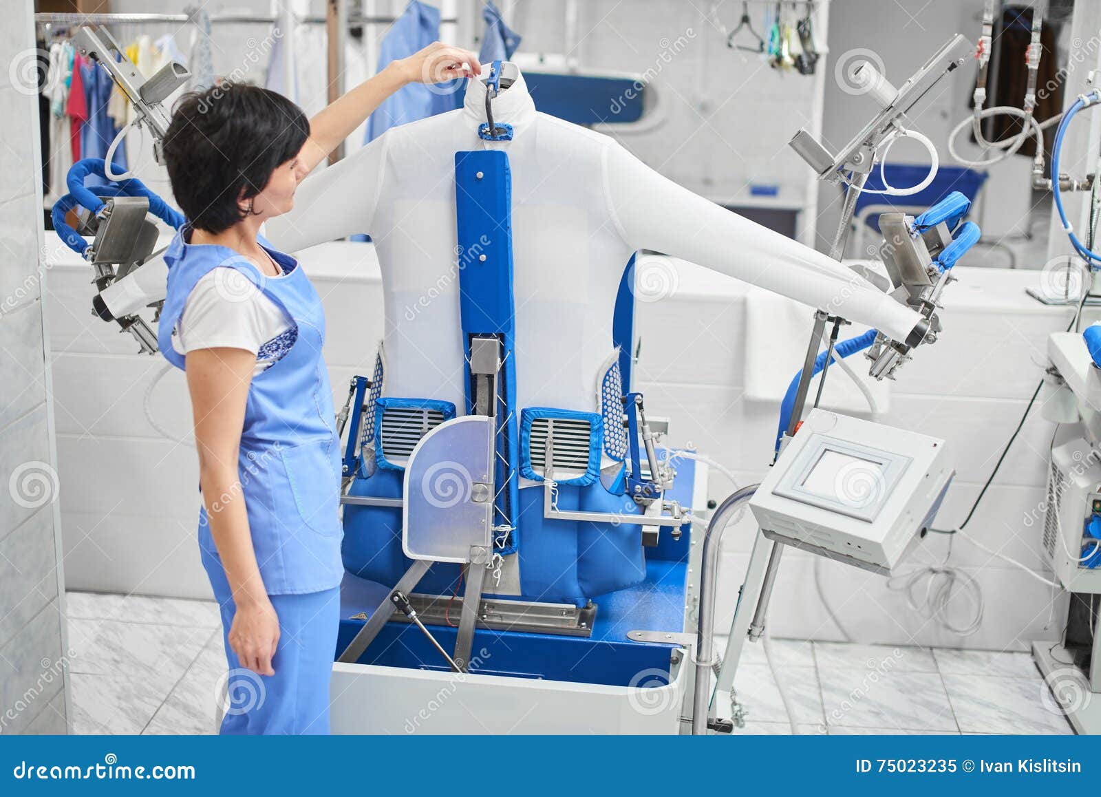 Woman Worker Laundry Ironed Clothes On The Automatic Steam ...