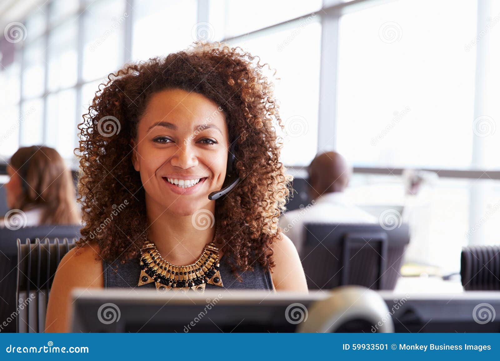 woman working in a call centre, looking to camera, close-up