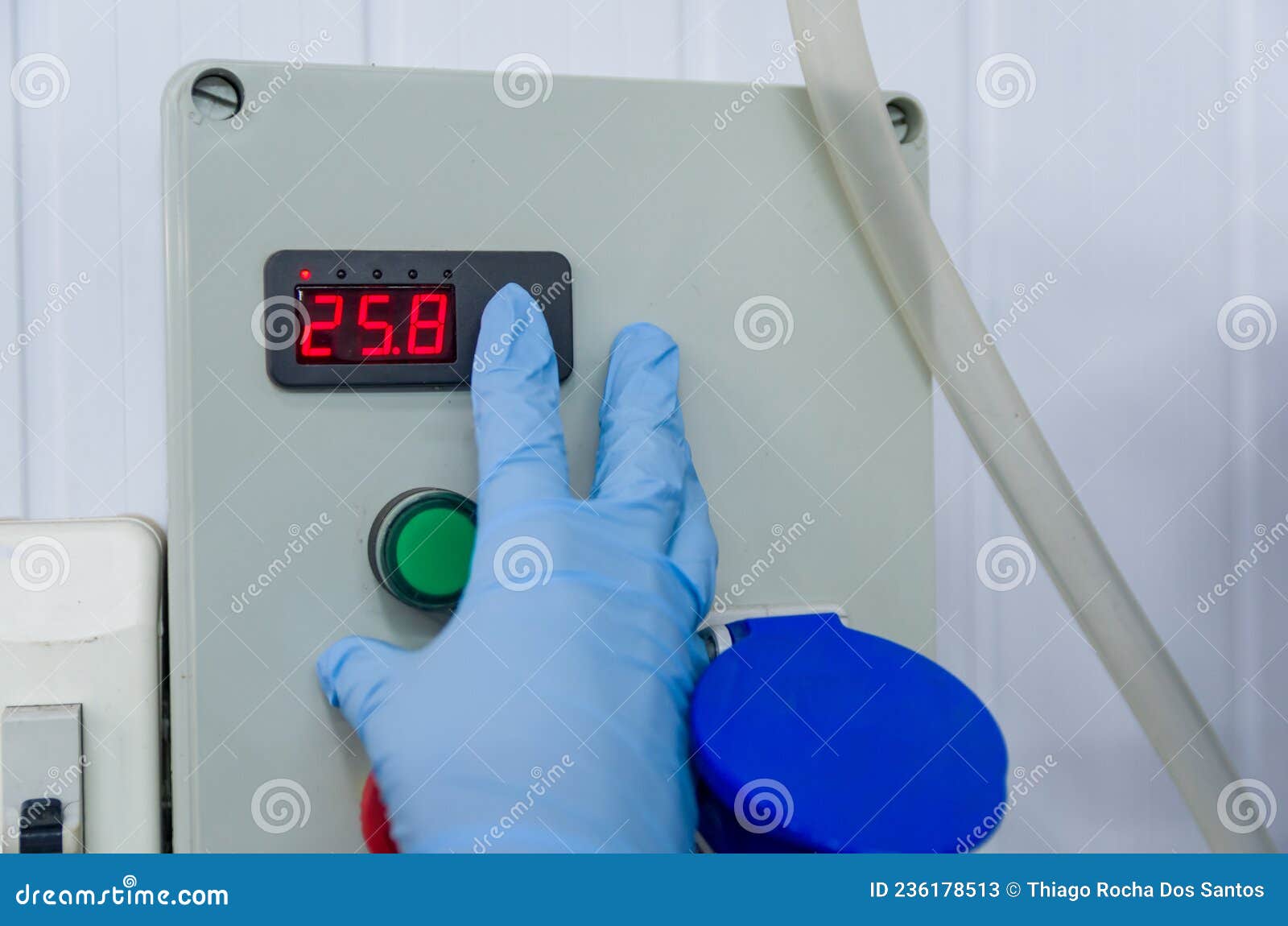 woman working in industry, adjusting tank thermostat