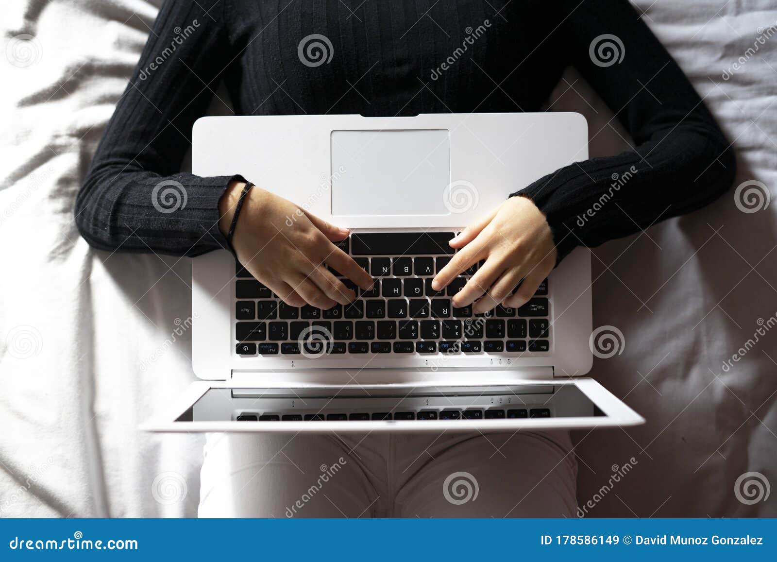 woman working with the laptop in bed