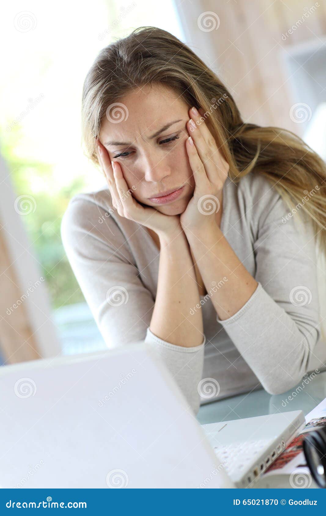 woman working on laptop getting tired