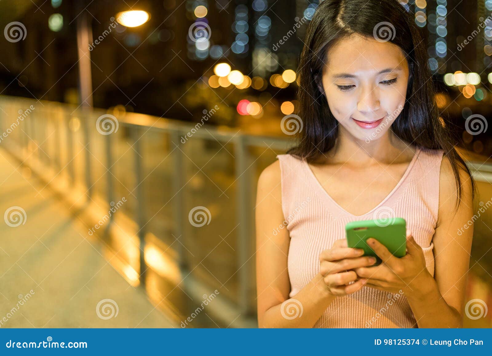 woman working on mobile phone at night