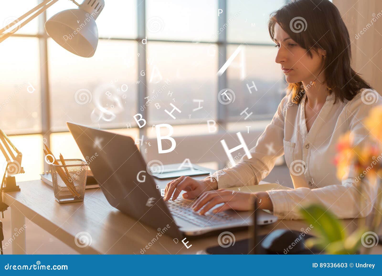 woman at workplace using laptop working, typing, surfing the internet