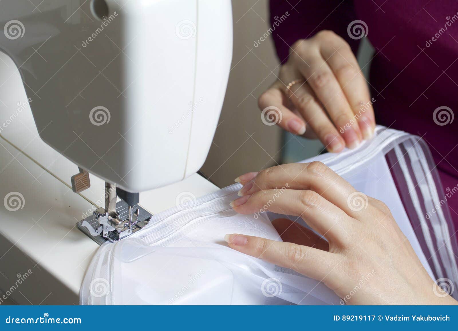 A Woman Works on a Sewing Machine. she Sews the Curtains on the Window Stock Image Image of