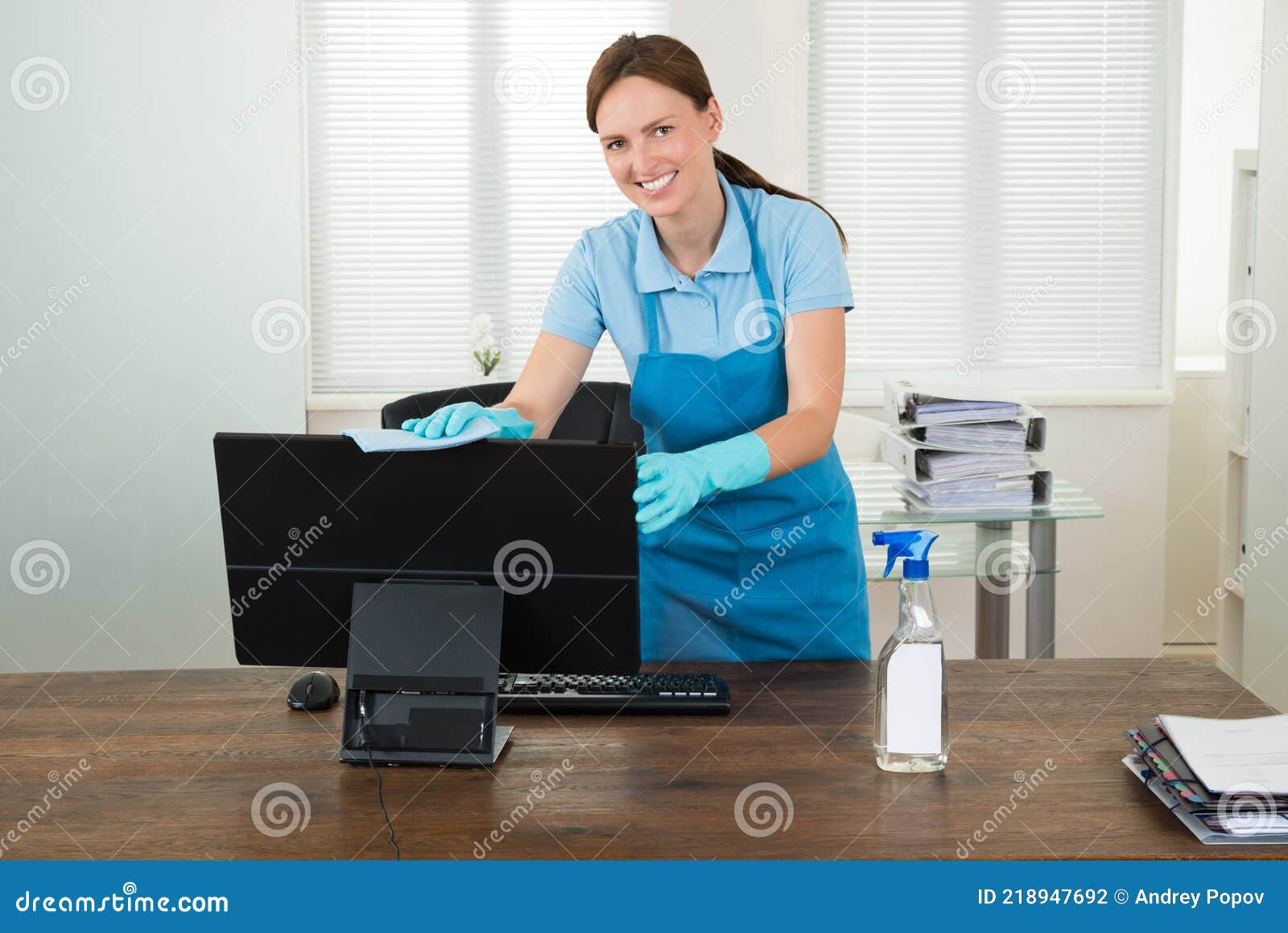 woman in workwear rubbing computer
