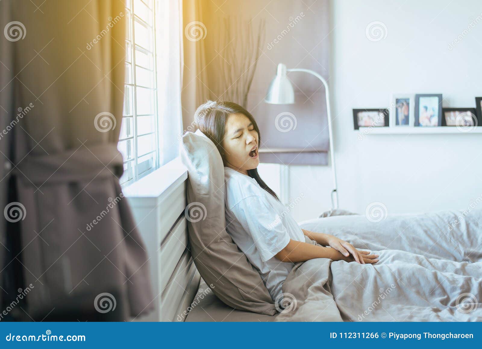 woman yawning on her bed and tired sleepy,symptoms and sleepiness