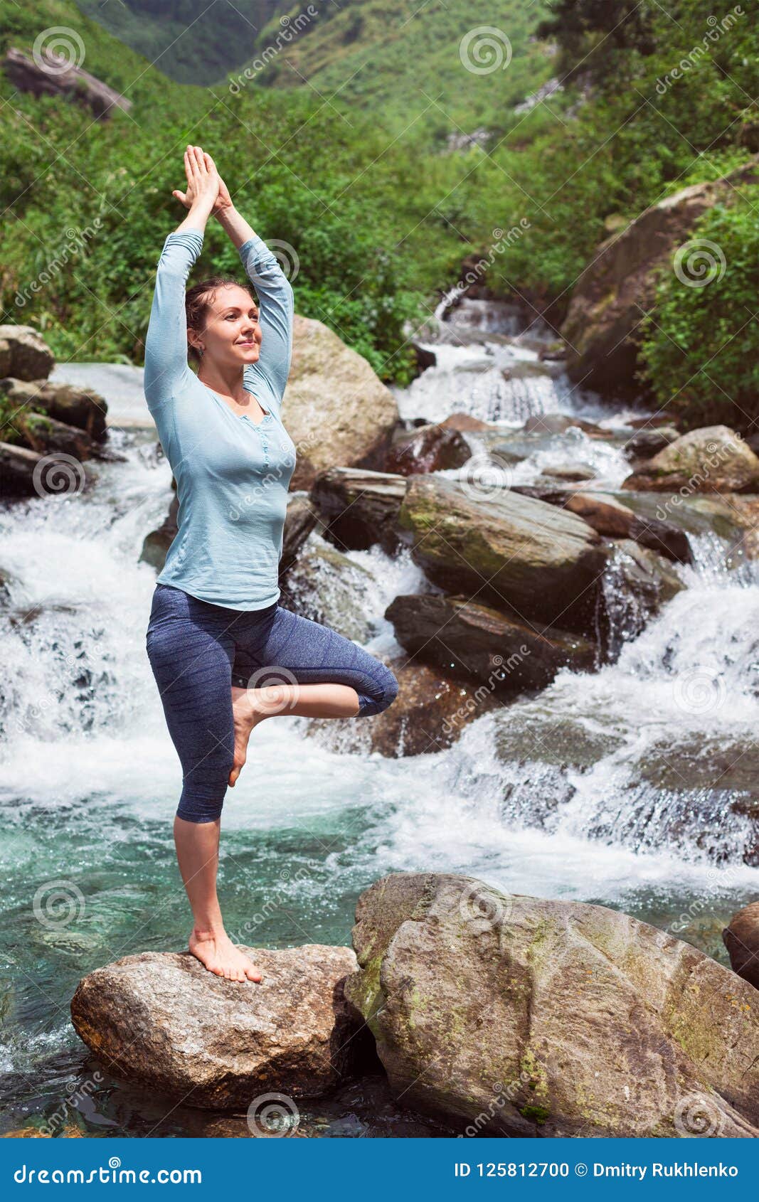 Woman In Yoga Asana Vrikshasana Tree Pose At Waterfall Outdoors Stock ...