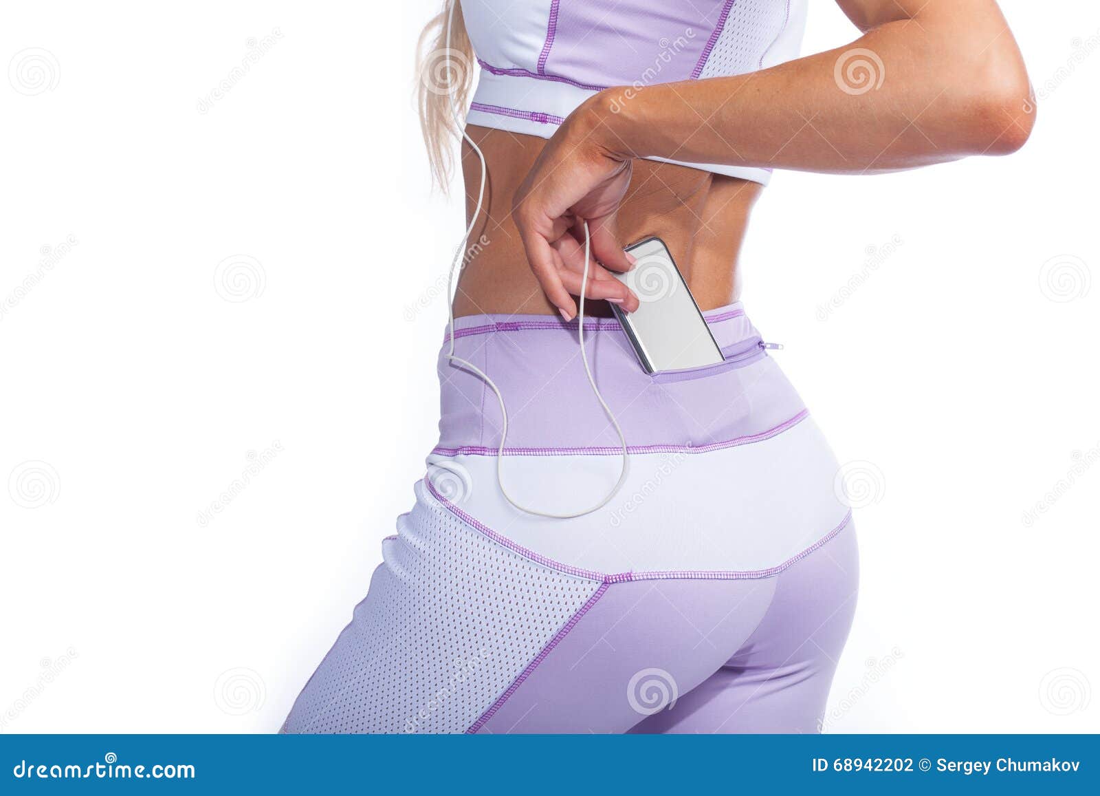Woman In Yoga Pants With Music Player In Pocket Back View