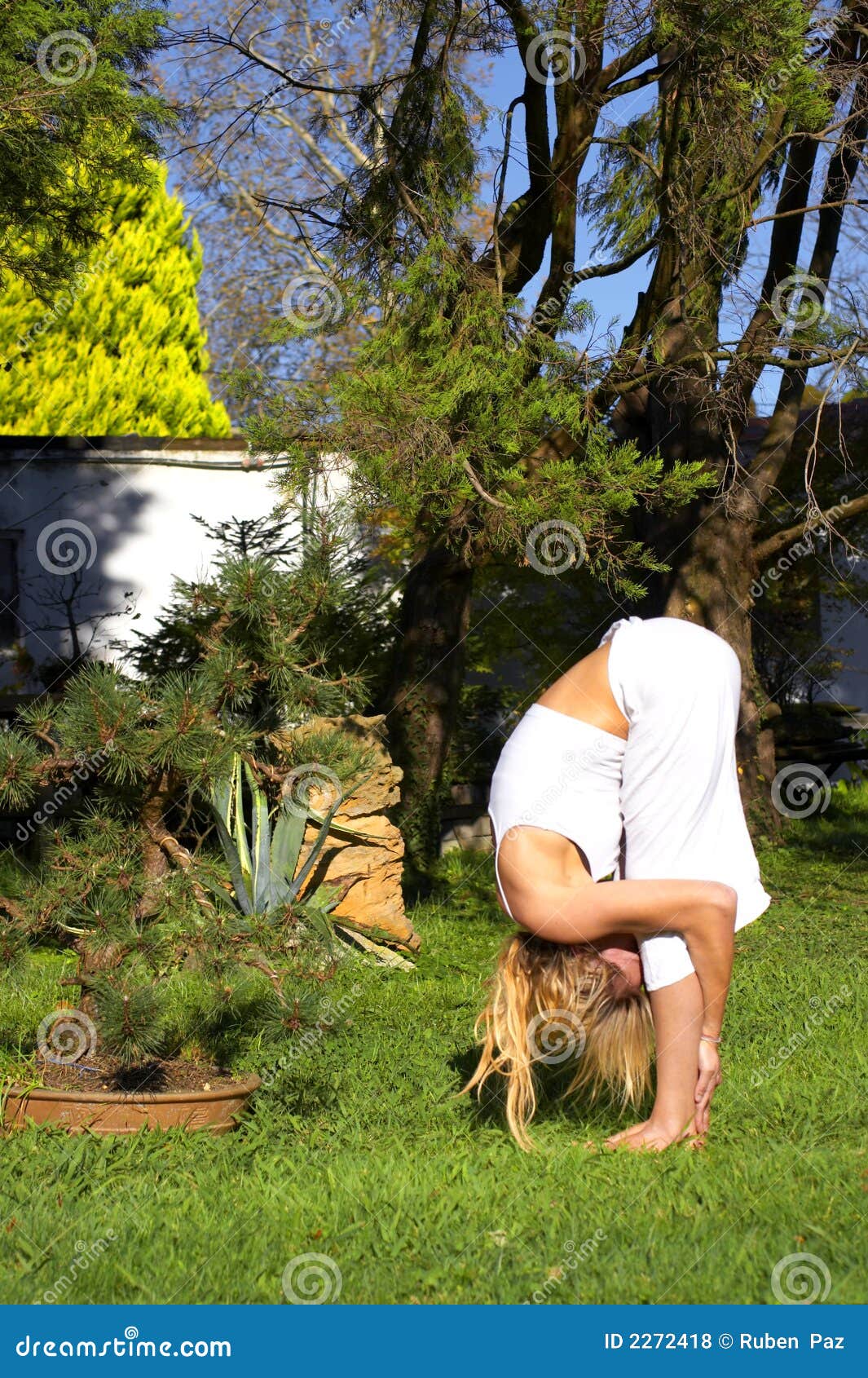 Woman In Yoga Pose In Garden Royalty Free Stock Photos