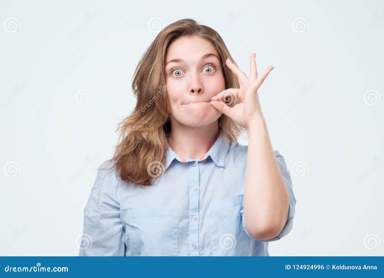 woman zipping her mouth shut - keeping quiet concept