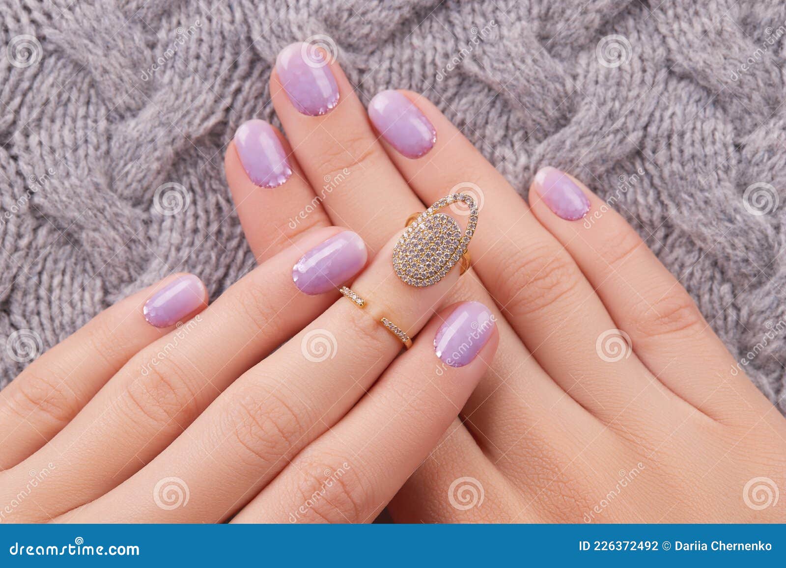 Close up womans hand with matte lavender nail design on gray background  Stock Photo - Alamy