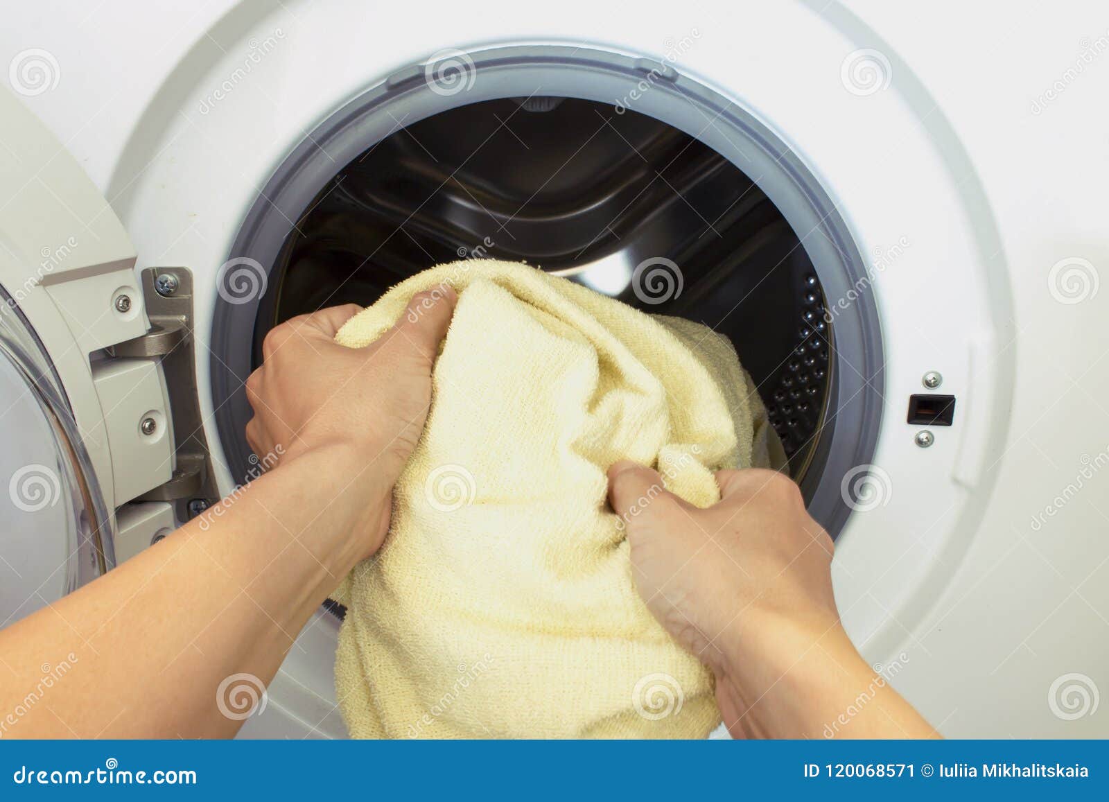 Womans Hands Pull the Laundry Out of or Load the Washing Machine Stock