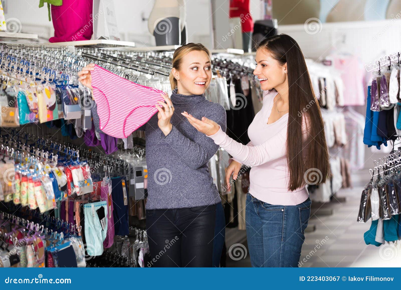 Two Happy Multiethnic Young Mixed Race Woman Shopping For Lingerie Near  Clothing Boutique Shop Window, Decide Whether To Stock Photo Image Of  Attractive, Bags: 131364946