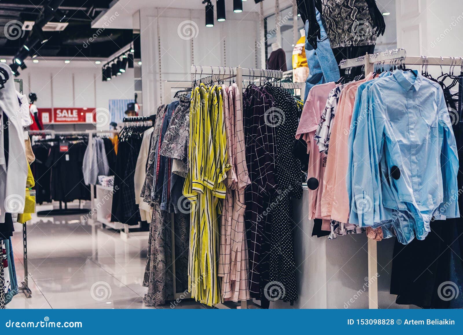 Women Clothes Hanging in the Fashion Store. Shopping Mall Stock