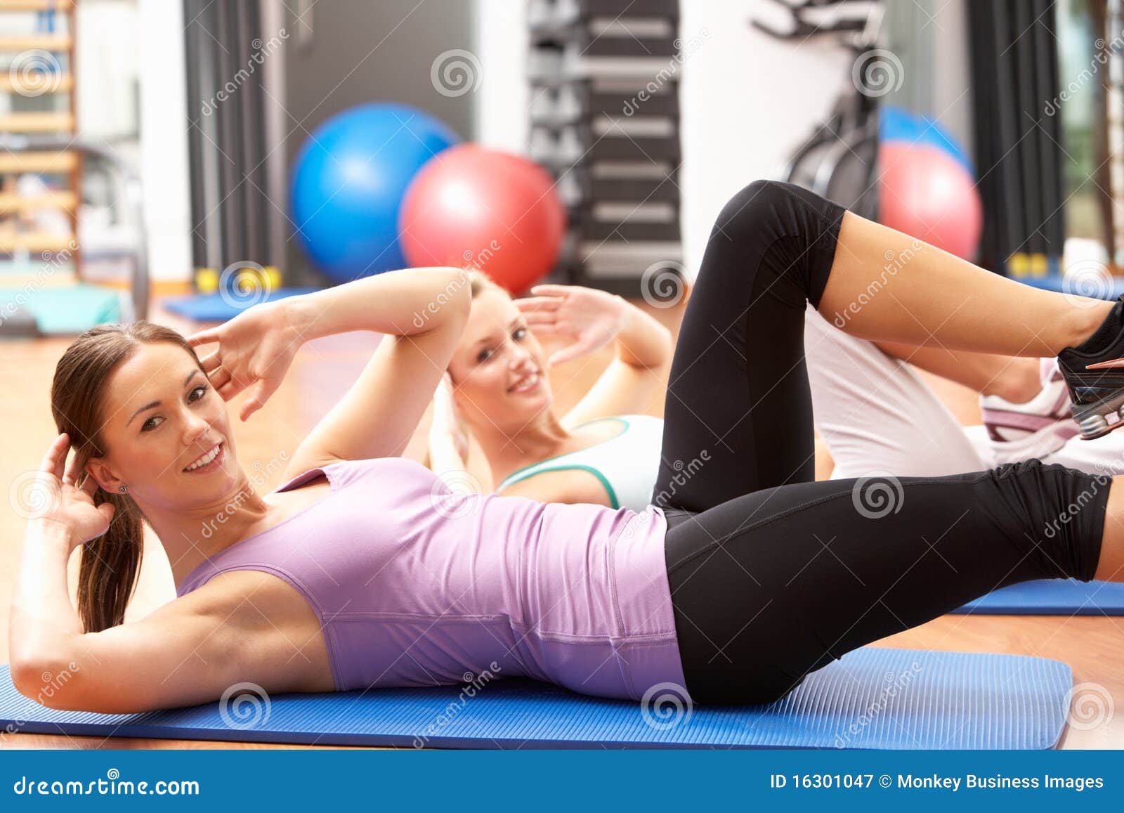 Woman Stretching at the Gym · Free Stock Photo