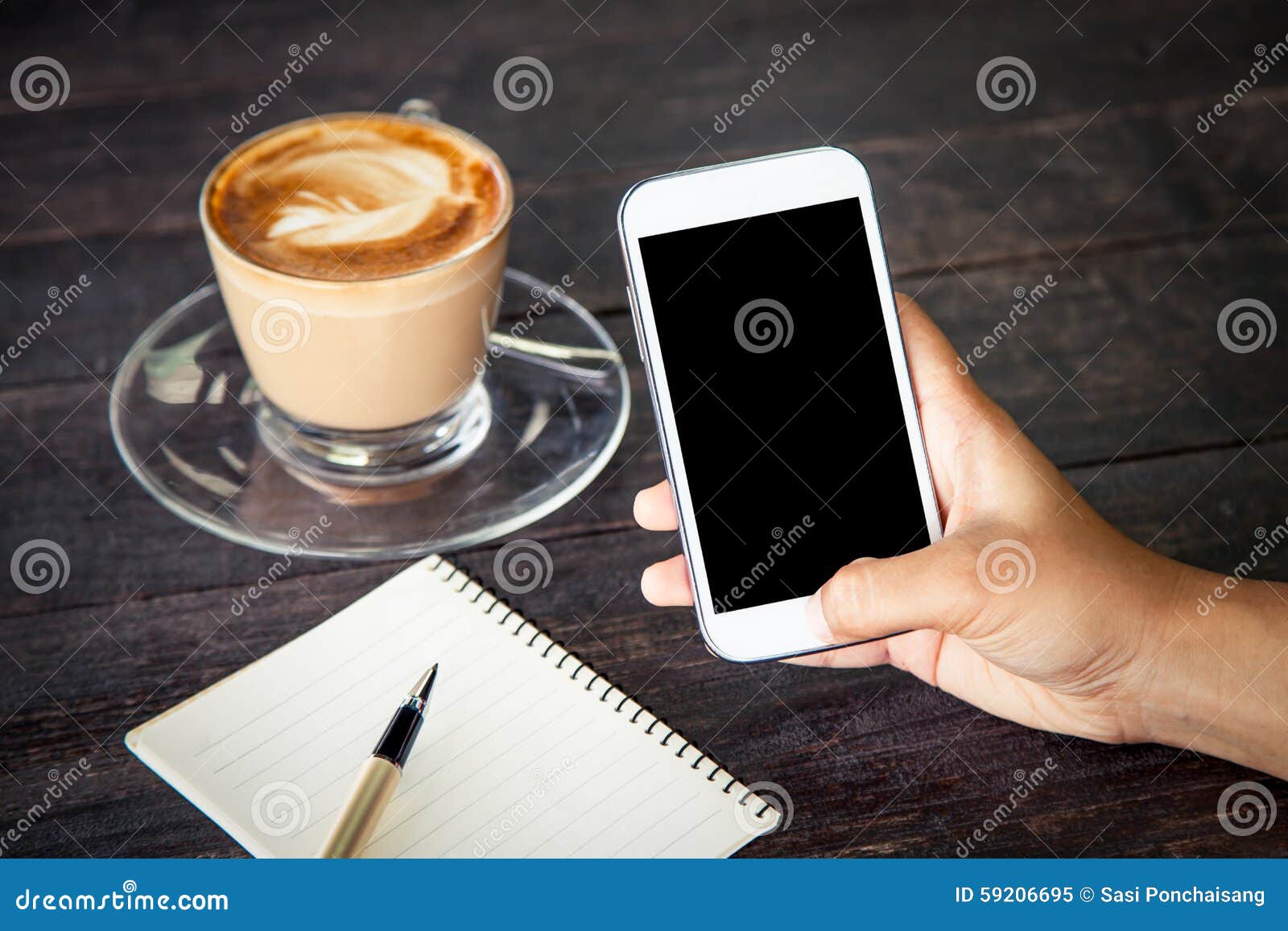 women hand using smartphone,cellphone,tablet over wooden table