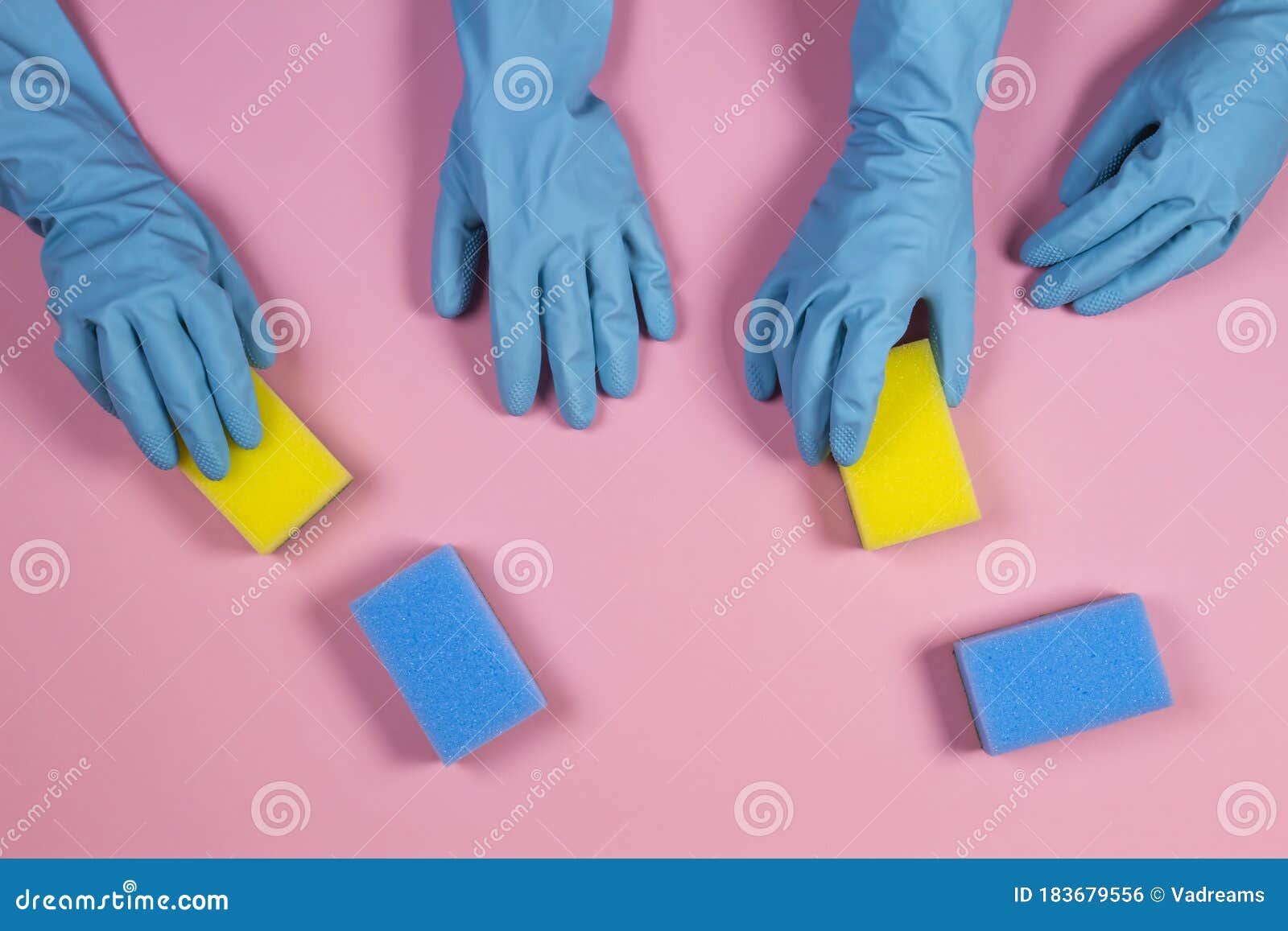 Women Hands In Light Blue Rubber Gloves With Sponges On Pink Background