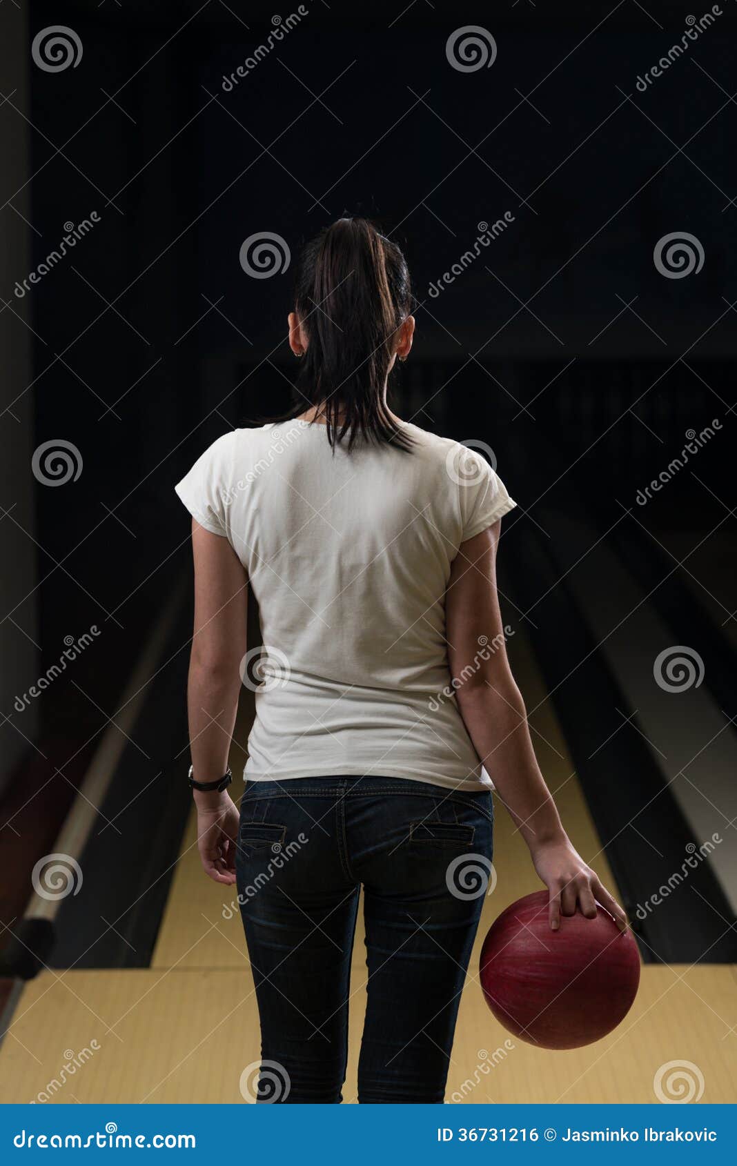 women holding a bowling ball