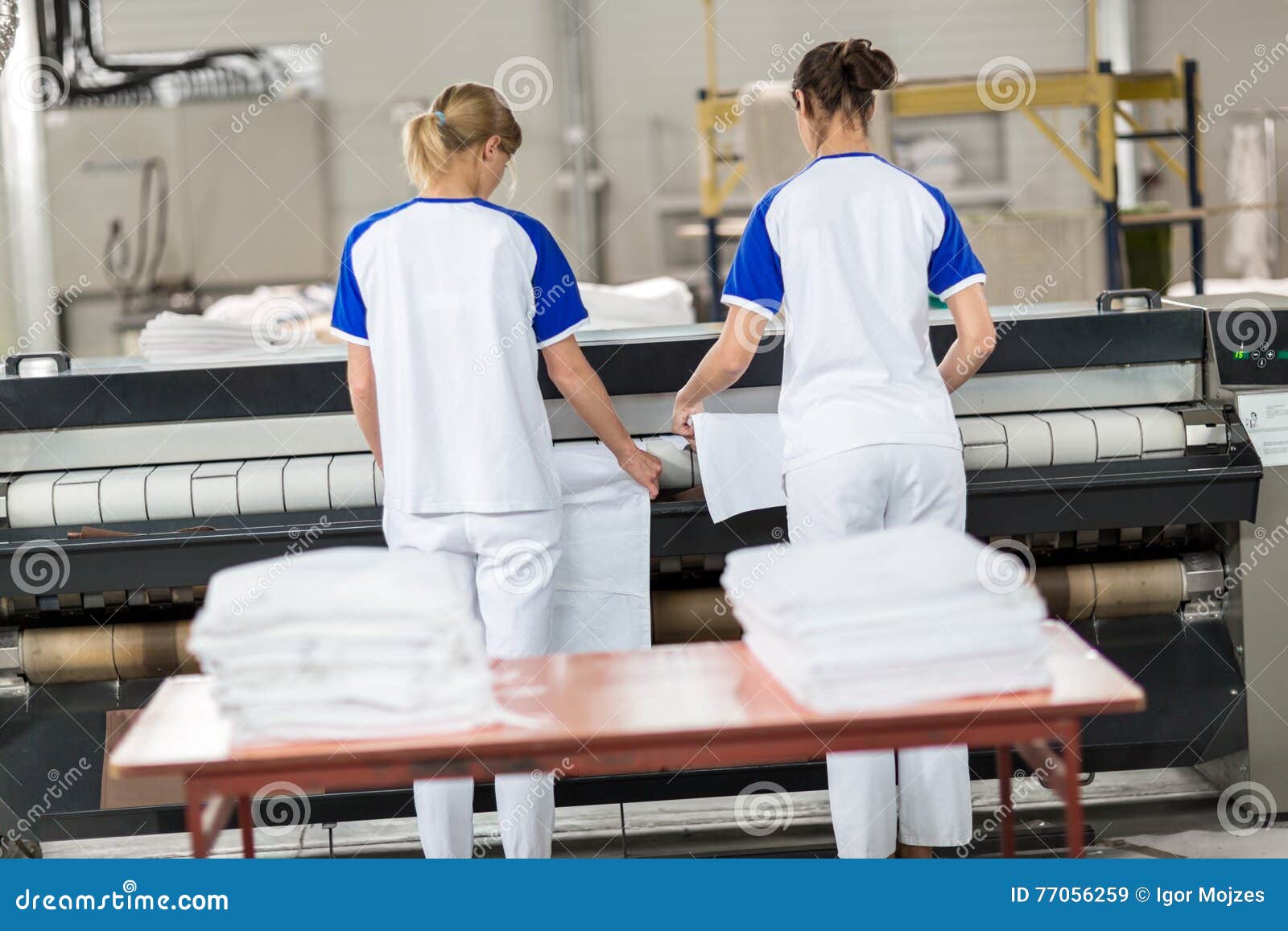 Women for ironing machine stock image. Image of plastic 77056259