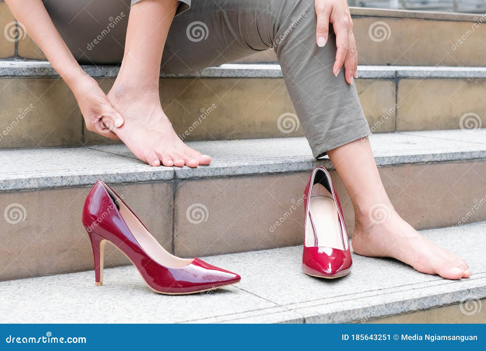 Women with Leg Cramps and Ankles from High Heels. she Sat on the Stairs ...