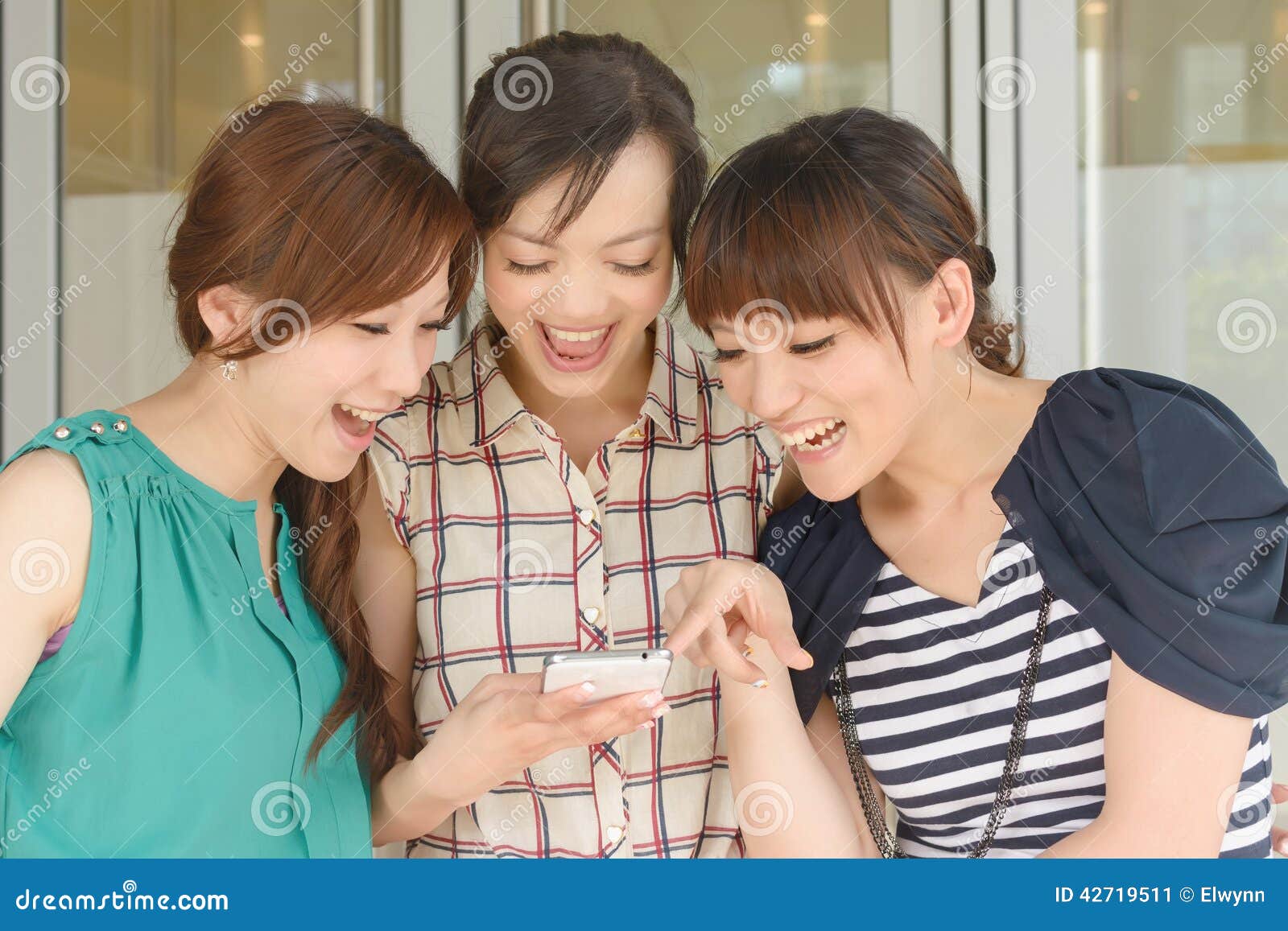 women looking at something on a cellphone
