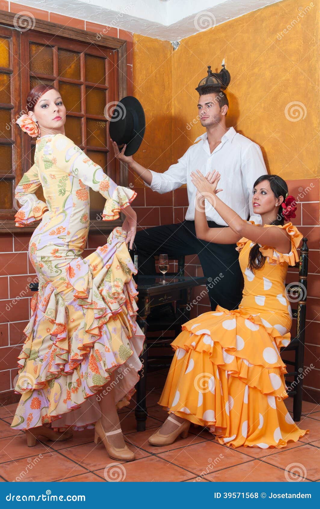 women and man in traditional flamenco dresses dance during the feria de abril on april spain