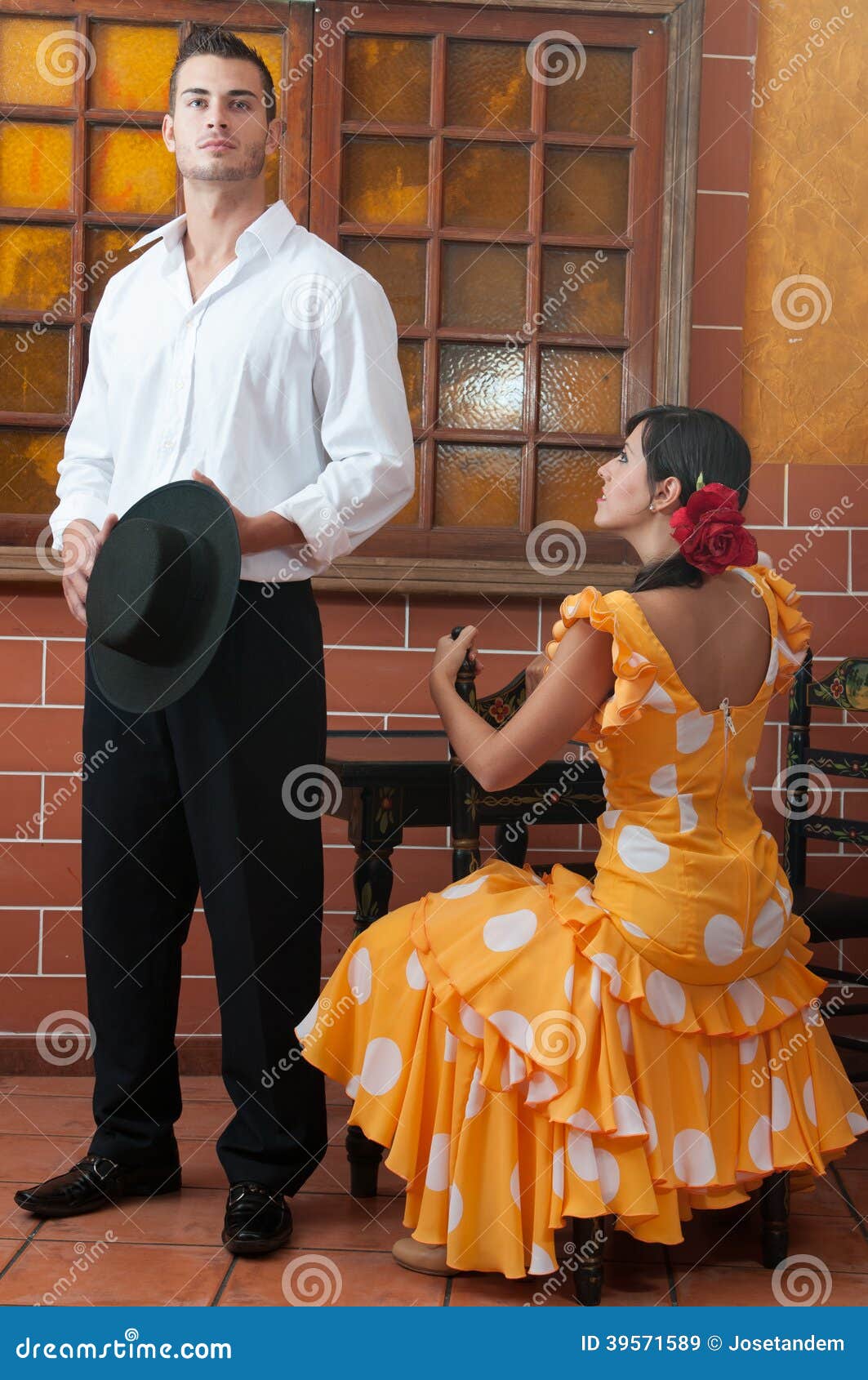 women and man in traditional flamenco dresses dance during the feria de abril on april spain