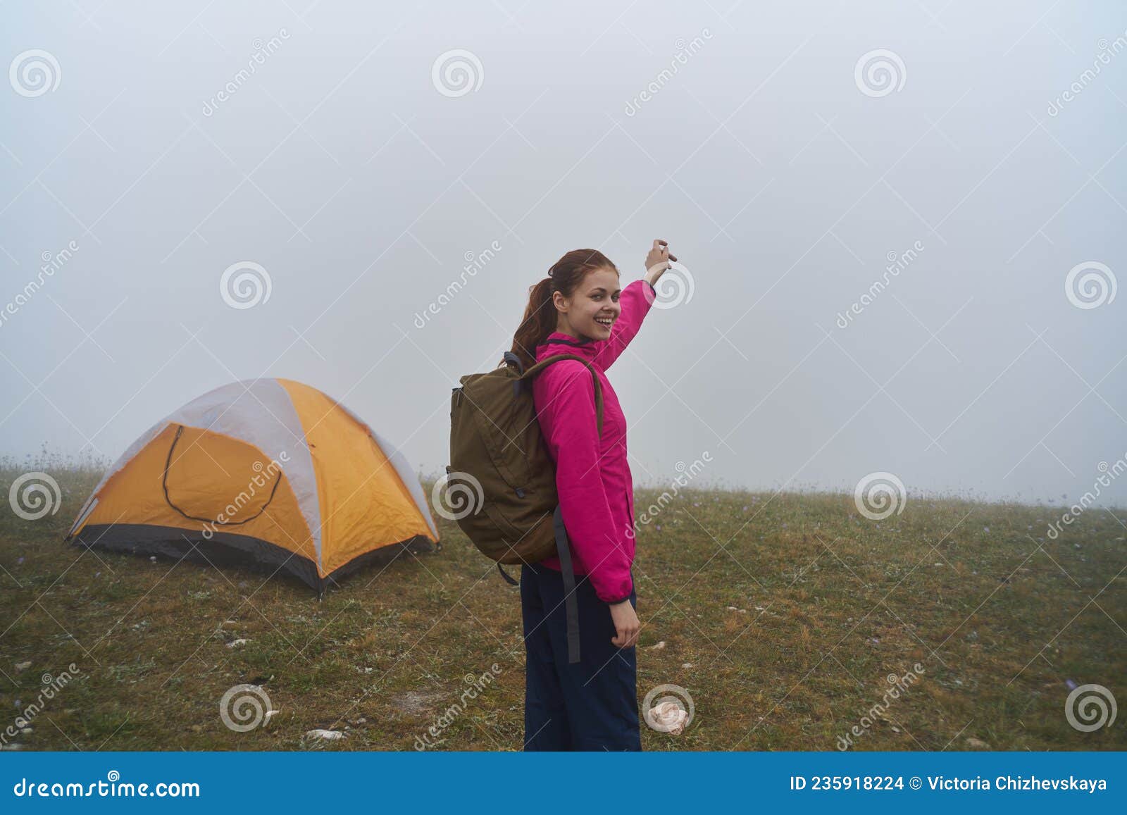 women in nature with a backpack in the mountains fog nature