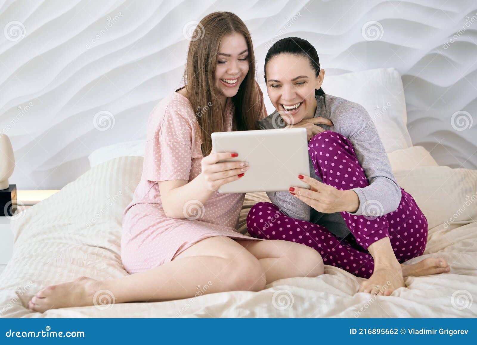 Mother with an Adult Daughter are Watching Funny Video on Screen of Tablet Computer while Sitting in Bed. Stock Photo - Image of sleepwear, nightgown: 216895662 Mother with an Adult Daughter are Watching Funny Video on Screen of Tablet Computer while Sitting in Bed. Stock Photo - Image of sleepwear, nightgown: 216895662