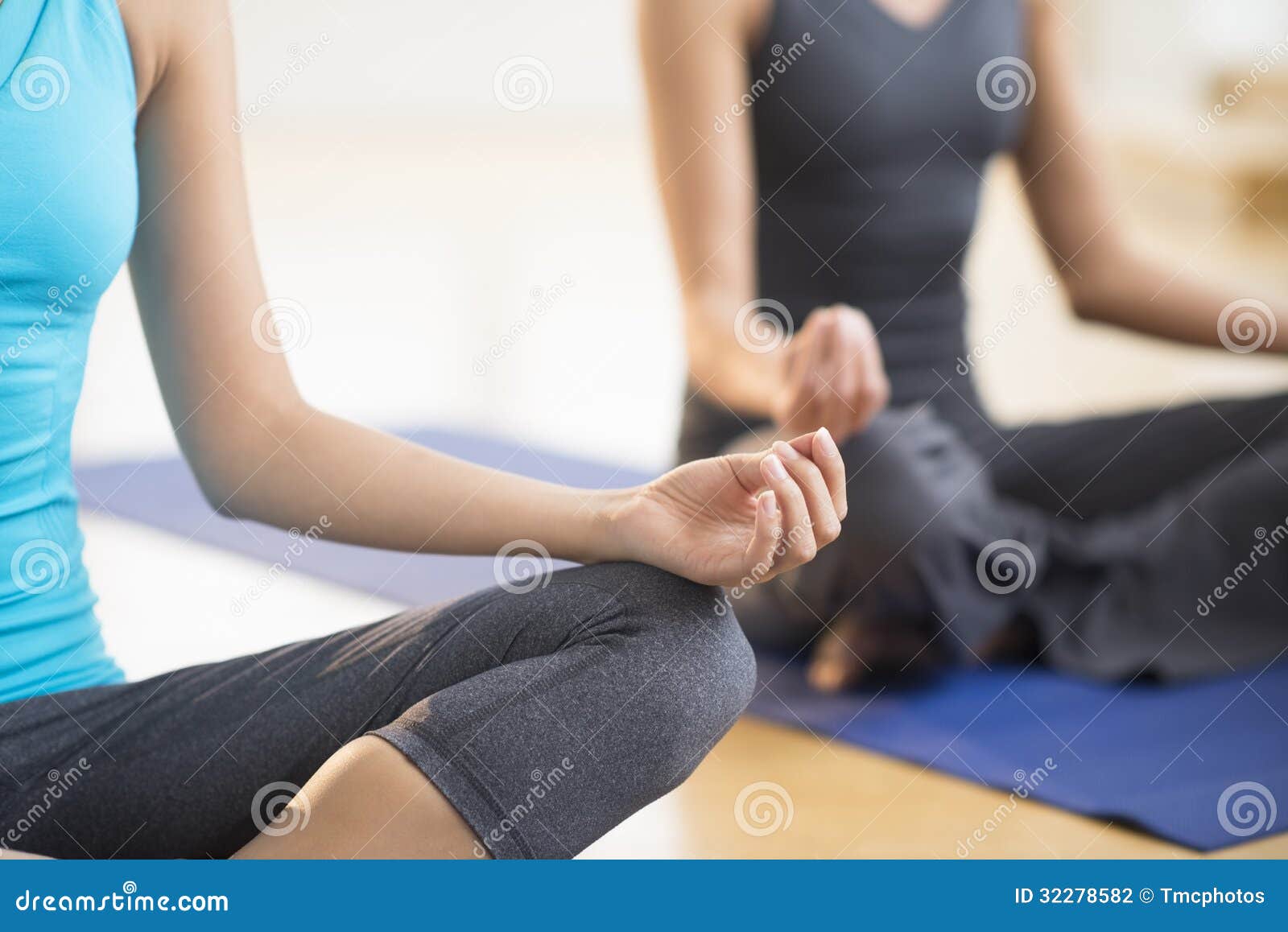 women practicing yoga at gym