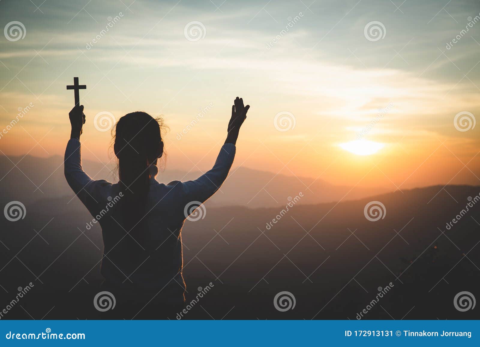 a women is praying to god on the mountain. praying hands with faith in religion and belief in god on blessing background. power of