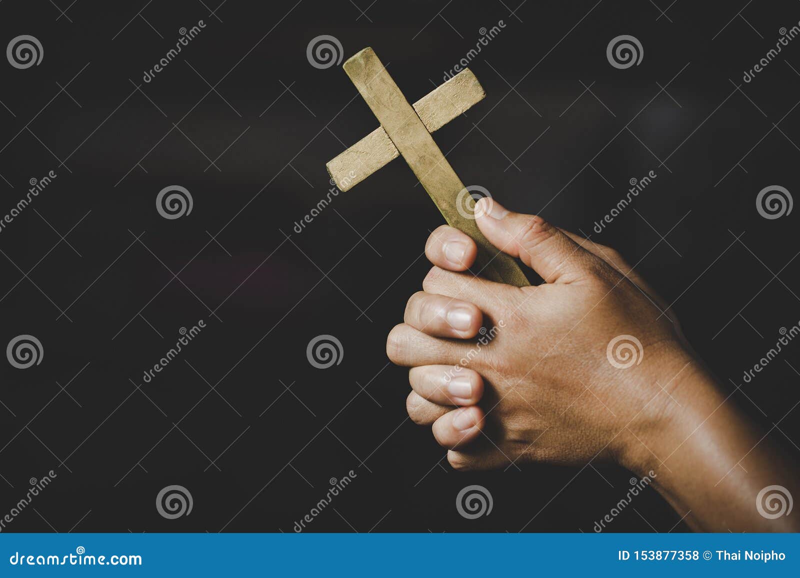 women in religious  hands praying to god while holding the cross .